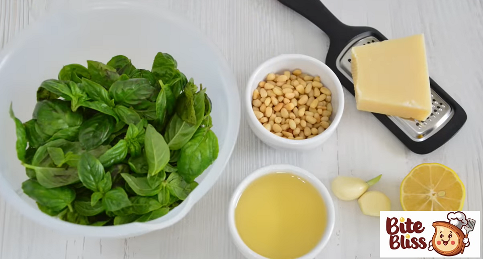 So we need 50 grams of green basil, 30 grams of pine nuts, also pine nuts are sometimes substituted for pine nuts. Nuts are sometimes replaced by cashews or almonds we will need 70 grams of parmesan, 70 milliliters of olive oil, a couple of cloves of garlic and half a lemon.